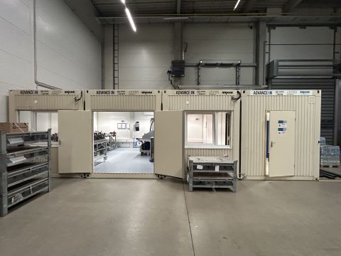 Modulární kontejnery IN26 – propojená DUO sestava pro technologické pracoviště Modulární kontejnery IN26 (ADVANCE IN) instalované uvnitř průmyslové haly – propojená DUO sestava se vstupem a oknem, zázemí technologického pracoviště, Brno CT Park